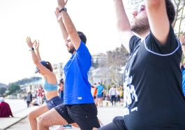 Group performing yoga outdoors along the scenic waterfront in İstanbul, Türkiye.